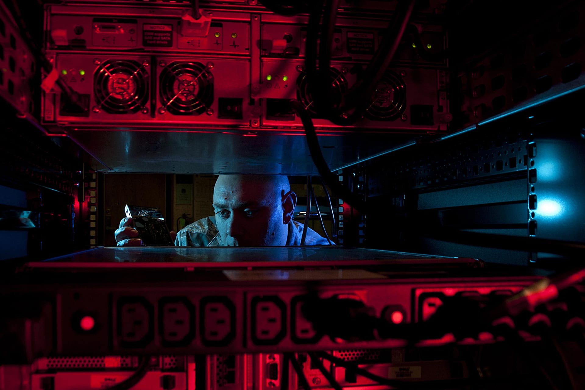 <p>U.S. Air Force Staff Sgt. Jerome Duhan, a network administrator with the 97th Communications Squadron, inserts a hard drive into the network control center retina server at Altus Air Force Base, Okla., on Jan. 24, 2014.</p>
