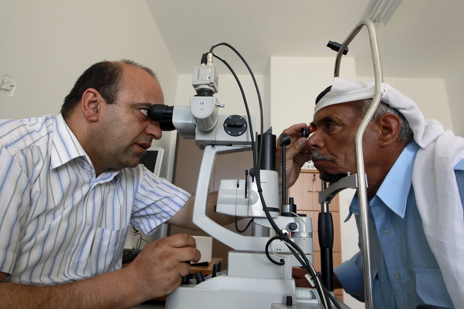 <p>A Palestinian doctor examines a patient’s eyes at a medical center in a refugee camp in the West Bank town of Bethlehem, on May 7, 2012. </p>
