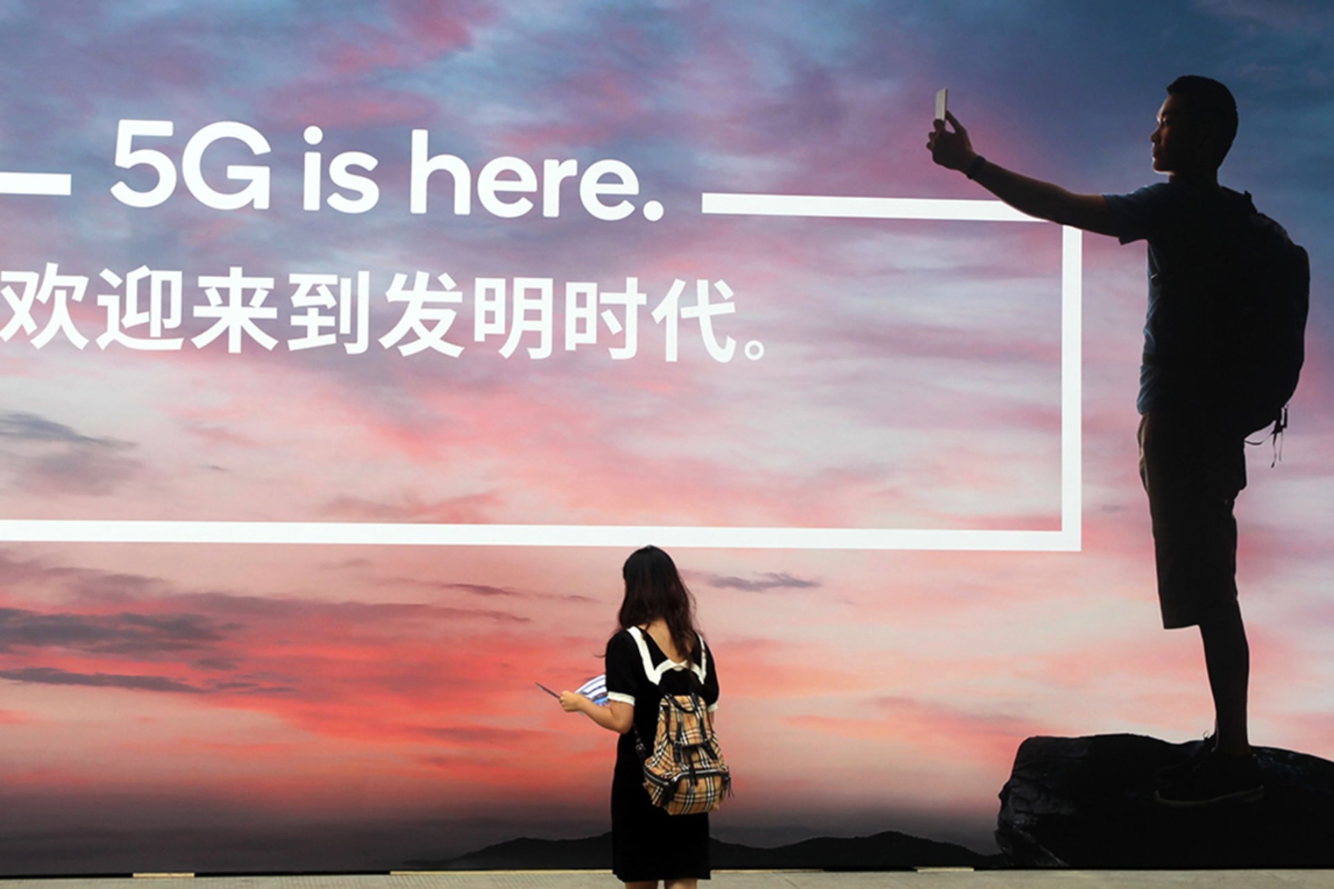 <p>A woman walks past a billboard reading ‘5G is here’ on day one of the Mobile World Congress (MWC) Shanghai 2019 at the Shanghai New International Expo Center on June 26, 2019 in Shanghai, China.</p>
