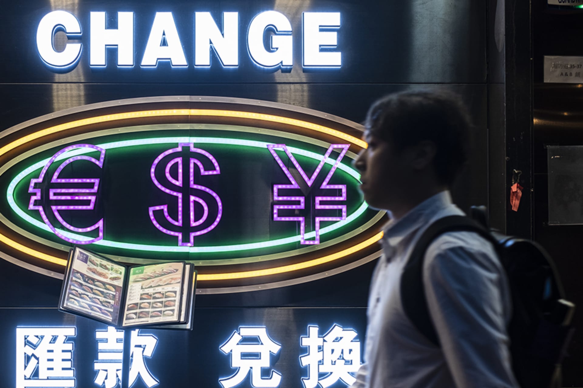 <p>A man passes by a currency exchange shop in Hong Kong, on May 29, 2019.</p>
