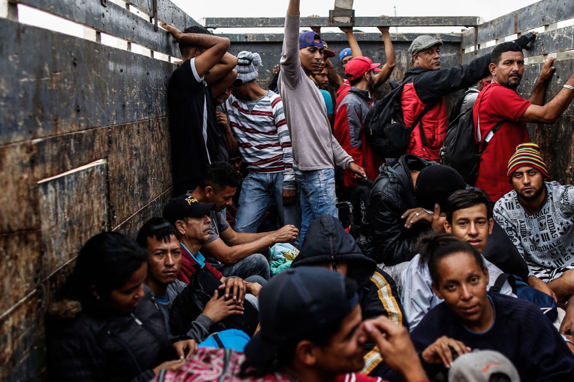 <p>Venezuelan migrants travel aboard a truck in Tumbes, Peru, on November 1, 2018.</p>
