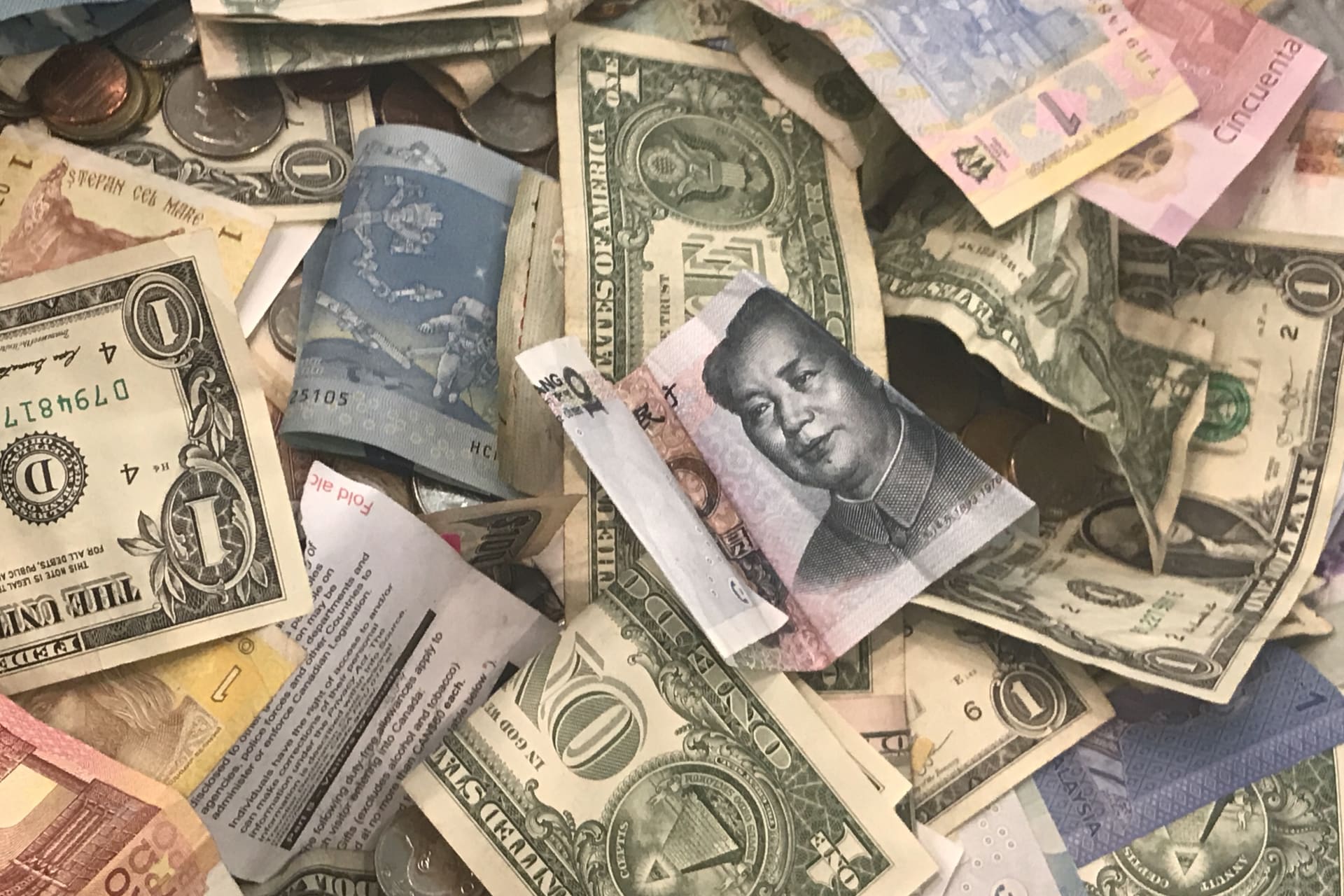 <p>U.S. dollars and other world currencies lie in a charity receptacle at Pearson international airport in Toronto, Canada, on June 13, 2018.</p>
