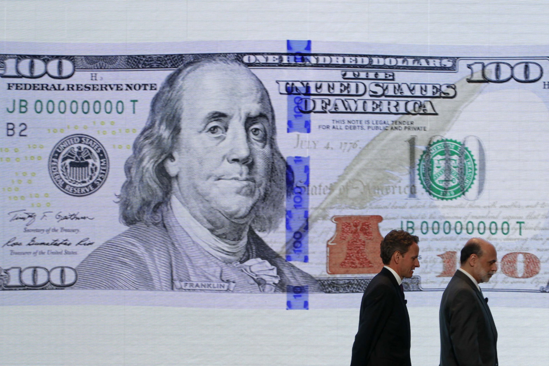 <p>U.S. Treasury Secretary Timothy Geithner (L) and Federal Reserve Chairman Ben Bernanke leave a ceremony to debut the new design for the US$100 note at the Department of the Treasury in Washington on April 21, 2010.</p>
