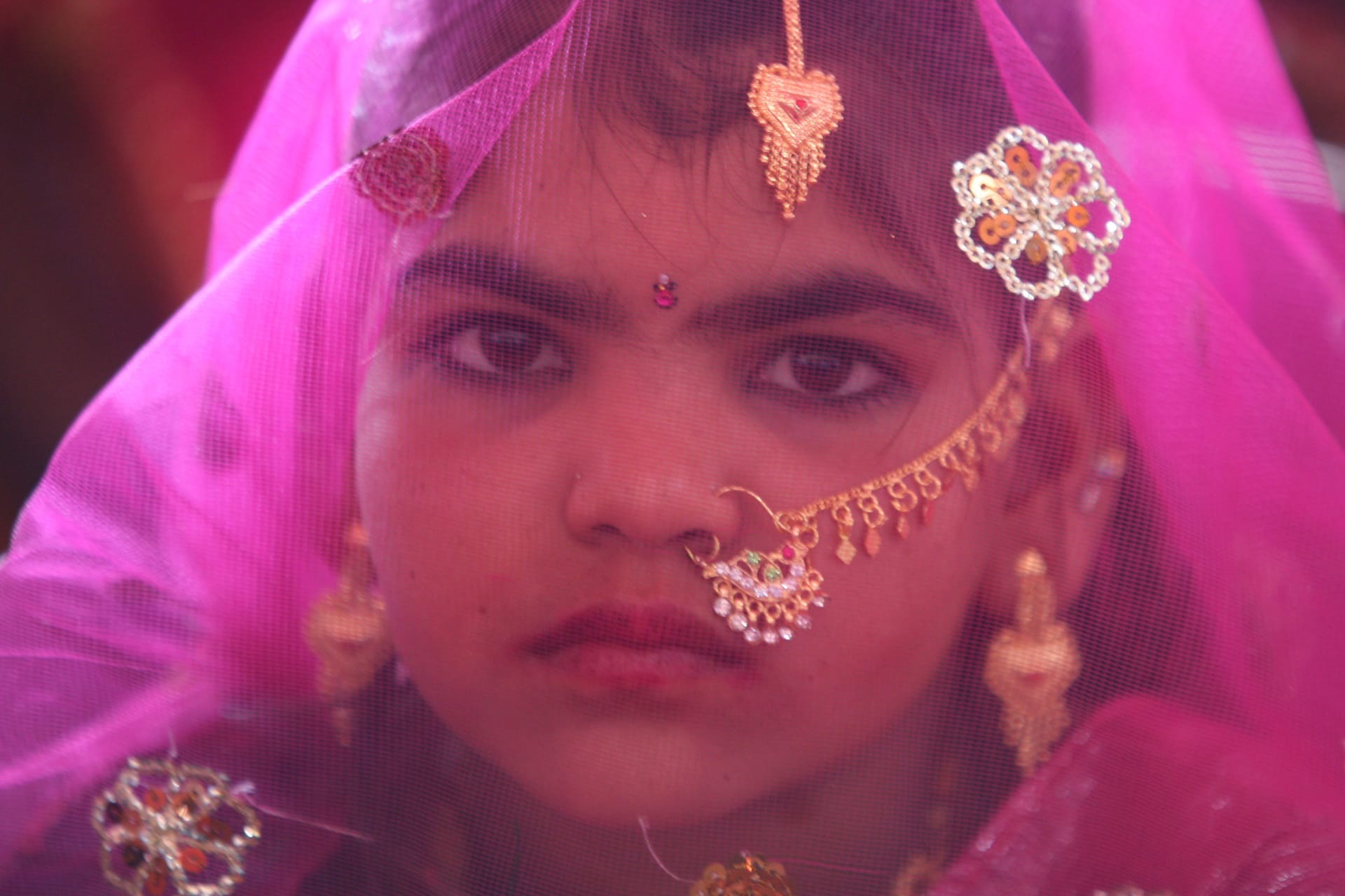 <p>A veiled girl from the Saraniya community waits for her engagement ceremony to start at Vadia village in the western Indian state of Gujarat on March 11, 2012.</p>