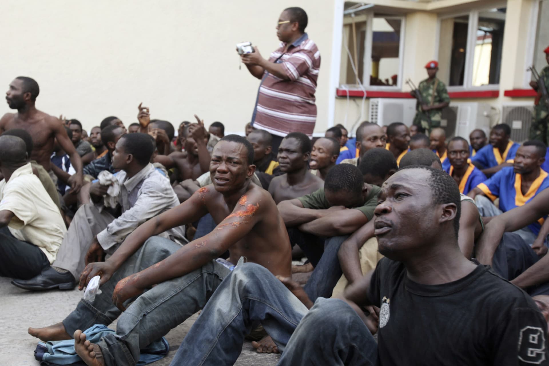 <p>More than 100 people, whom authorities arrested for what they say are their links to a thwarted attack on President Joseph Kabila’s residence, are displayed to the media in Kinshasa on March 7, 2011.</p>