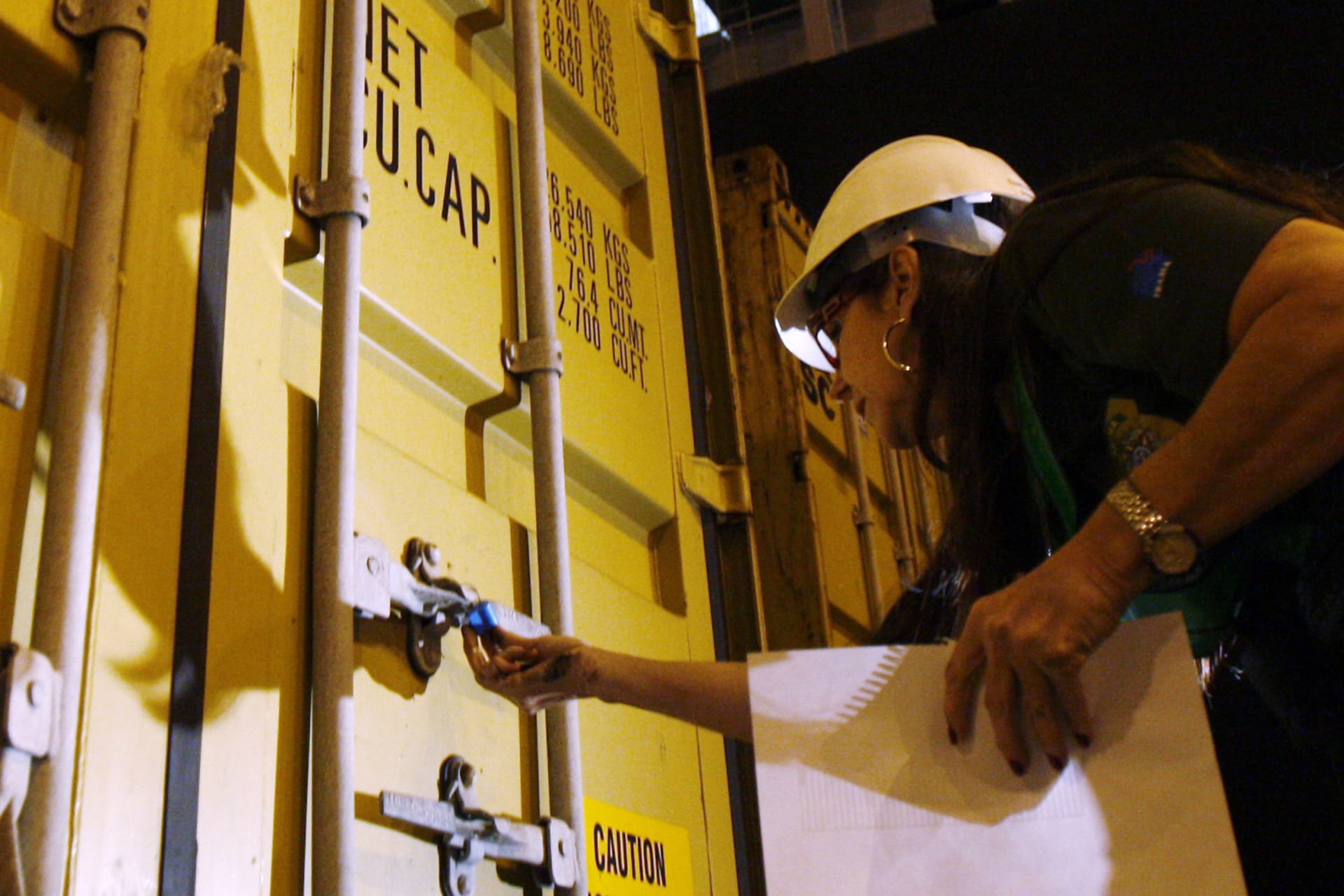 <p>An IBAMA (Brazilian Institute of Environment and Renewable Natural Resources) agent inspects a container filled with rubbish from Britain before it is loaded onto a ship at the port of Santos on August 4, 2009.</p>
