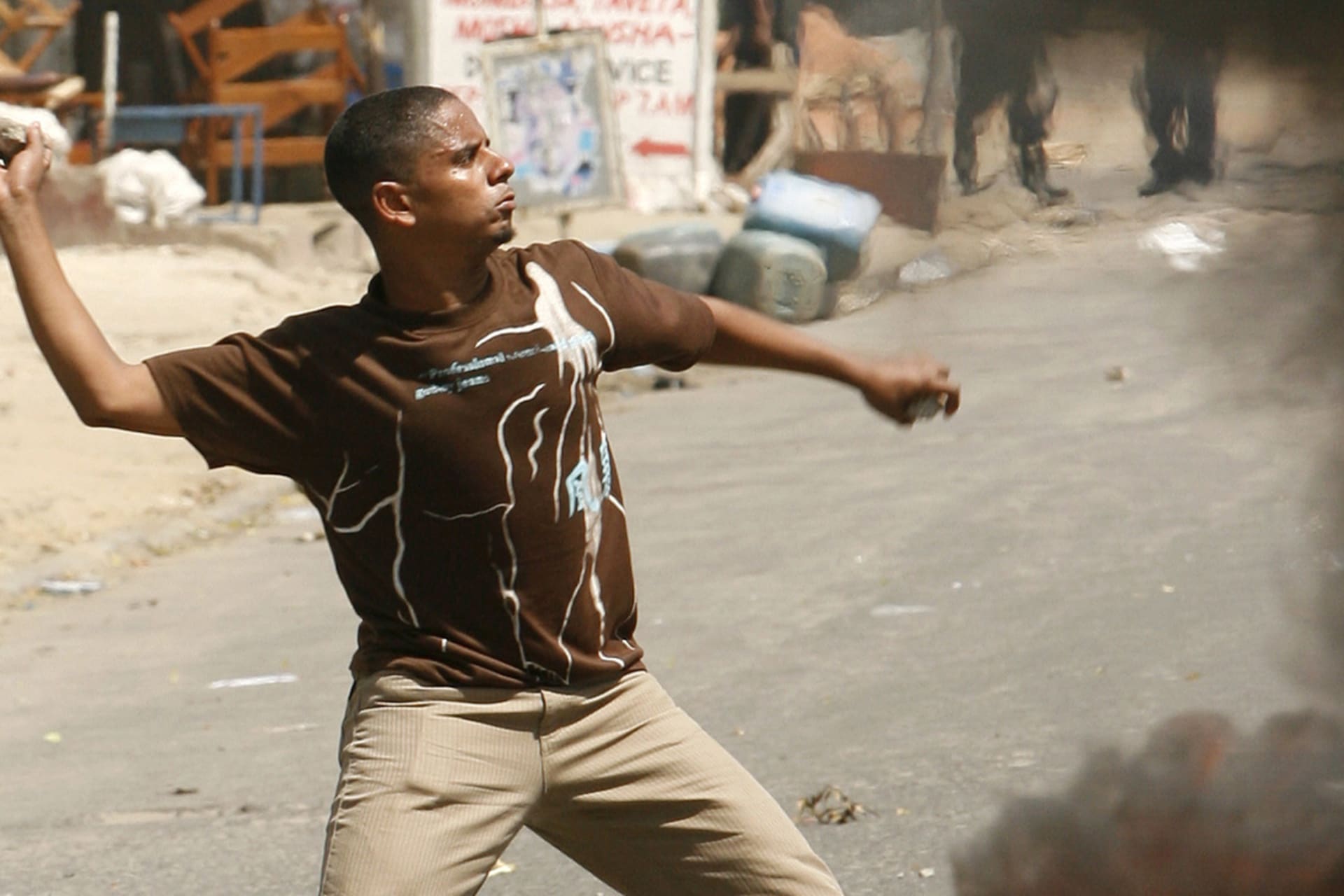 <p>A protester hurls rocks at the police during a demonstration in the port city of Mombasa on January 18, 2008.</p>