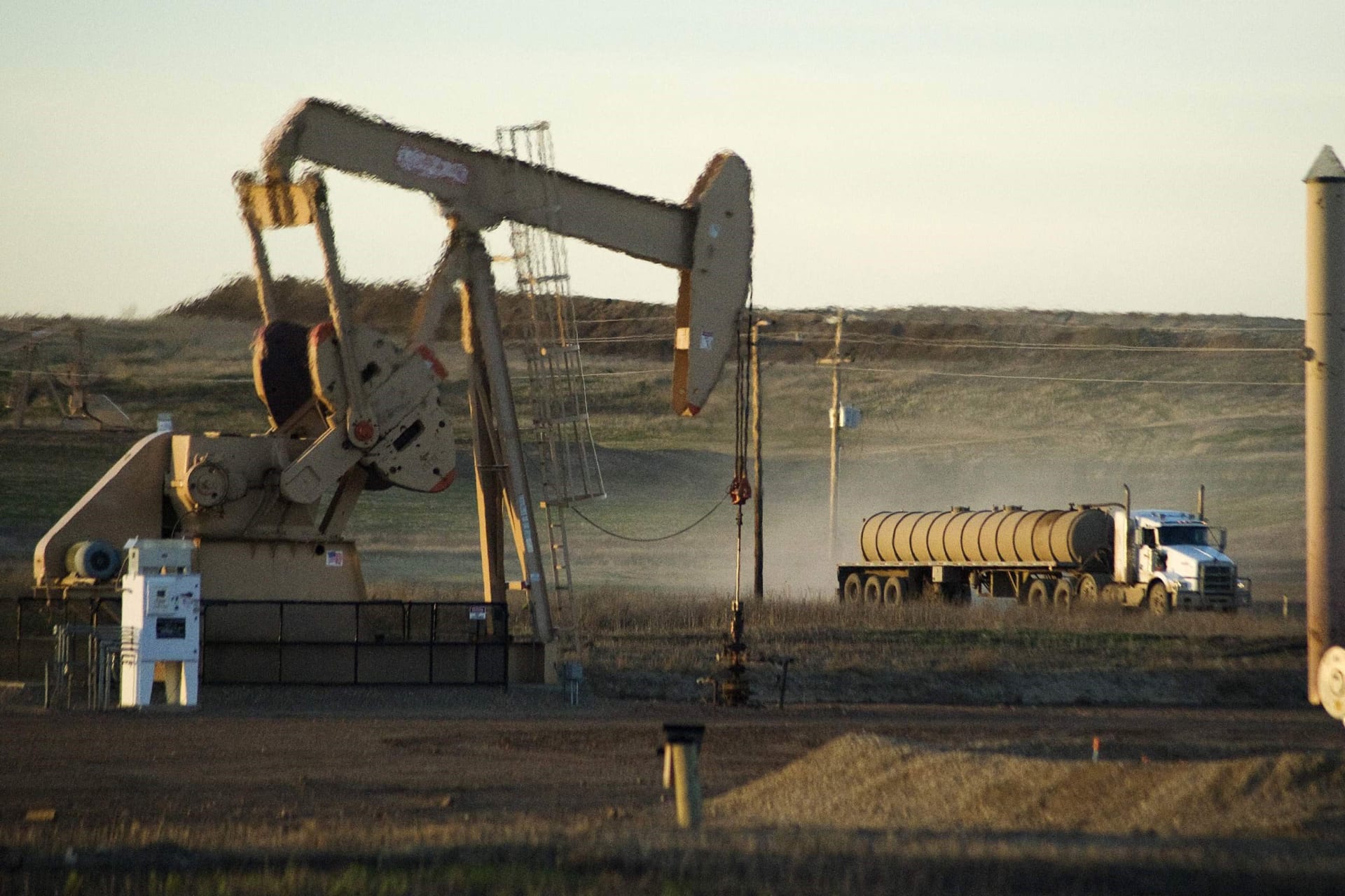 <p>A service truck drives past an oil well on the Fort Berthold Indian Reservation in North Dakota on November 1, 2014.</p>
