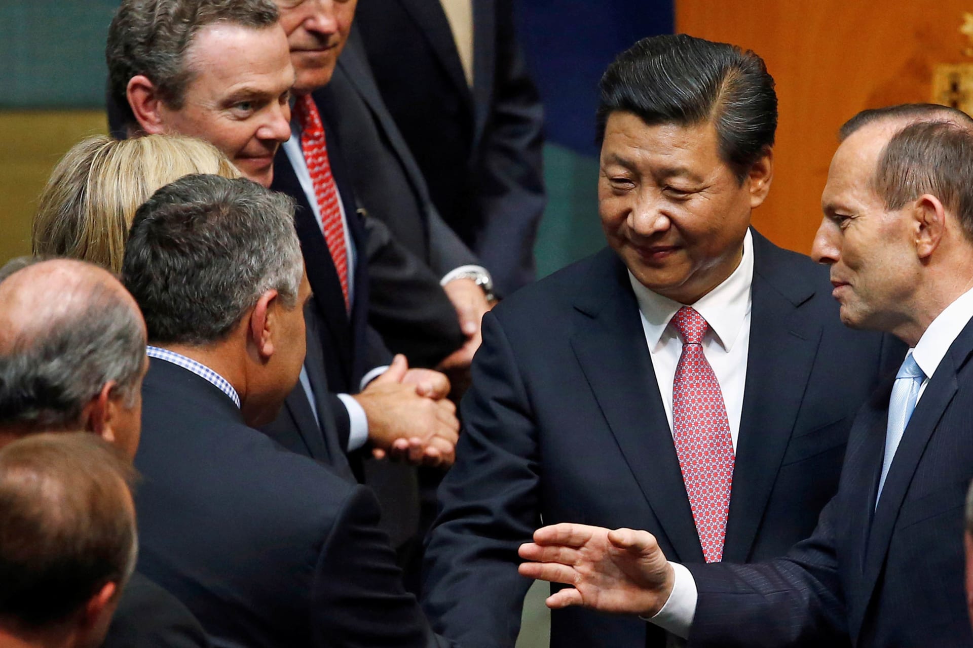 <p>China’s President Xi Jinping (C) is introduced by Australian Prime Minister Tony Abbott (R) to members of parliament after he spoke in the House of Representatives at Parliament House in Canberra on November 17, 2014.</p>

