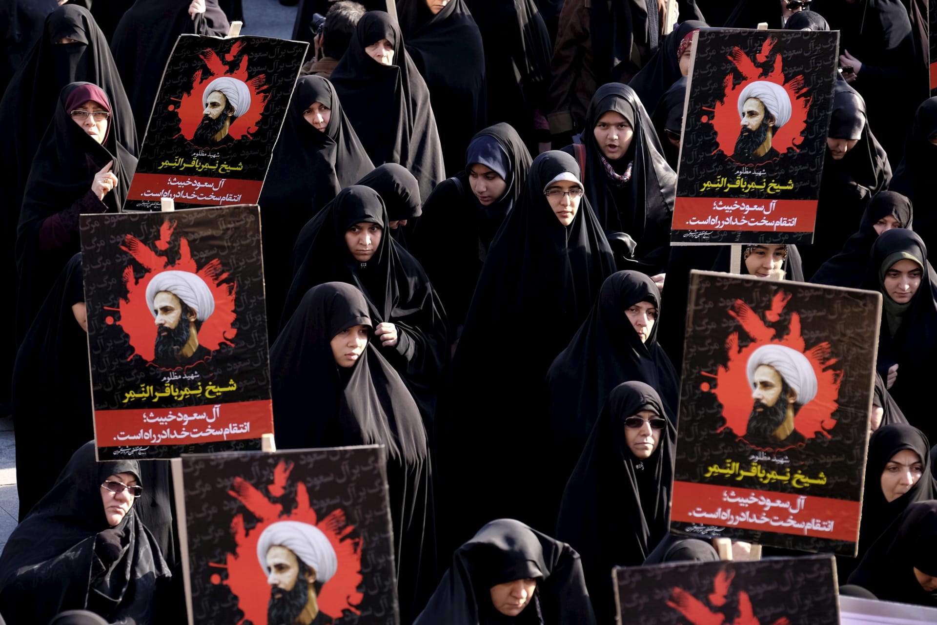 <p>Iranian protesters hold pictures of prominent Shiite cleric Sheikh Nimr al-Nimr during a demonstration against the execution of al-Nimr in Saudi Arabia, at Imam Hussein Square in Tehran, Iran, on Jan. 4, 2016.</p>
