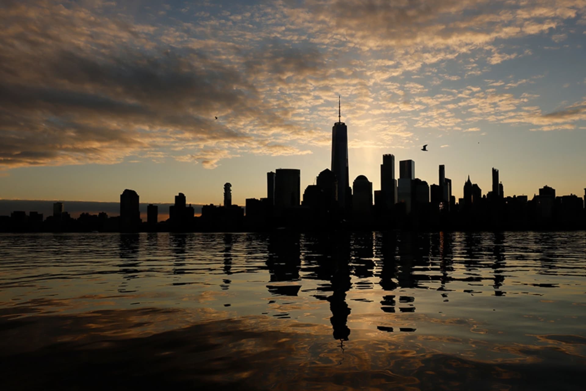 <p>The skyline of New York City’s lower Manhattan is reflected in the Hudson River.</p>
