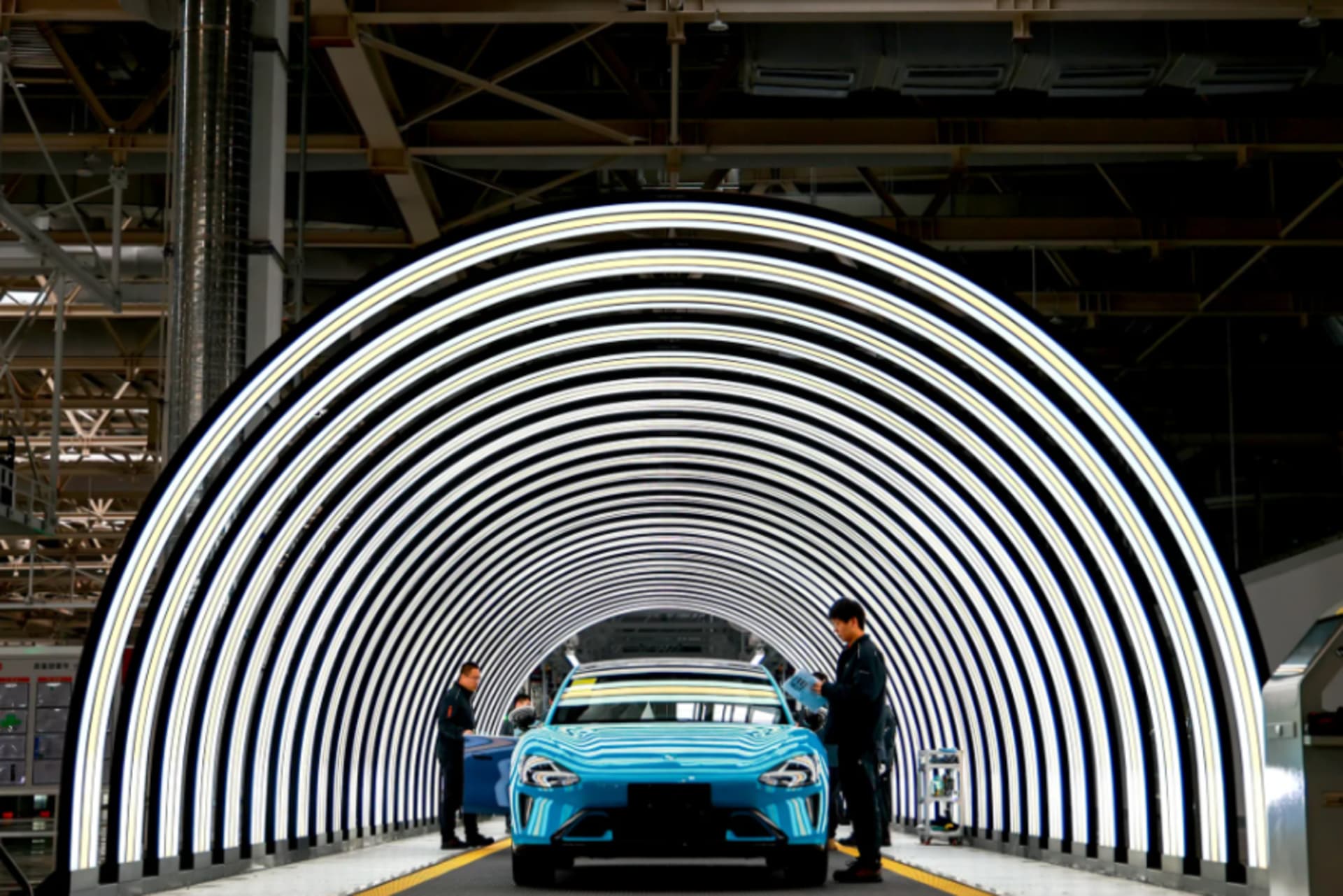 <p>Xiaomi’s electric vehicle factory in Beijing. Employees inspecting car on production line.</p>
