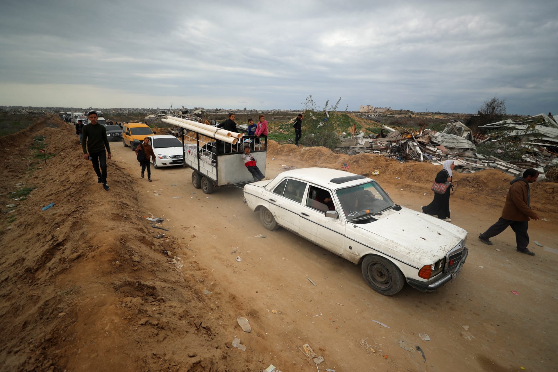 Palestinians make their way after Israeli forces withdrew from the Netzarim Corridor, near Gaza City