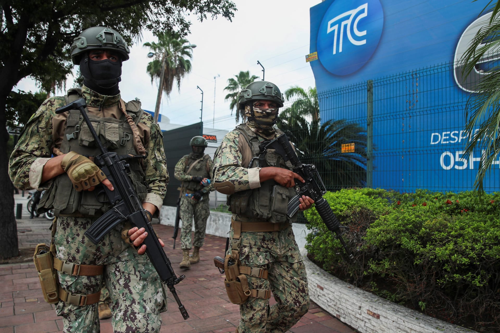 Ecuadorian soldiers patrol outside of tv station after it was attacked by gunmen