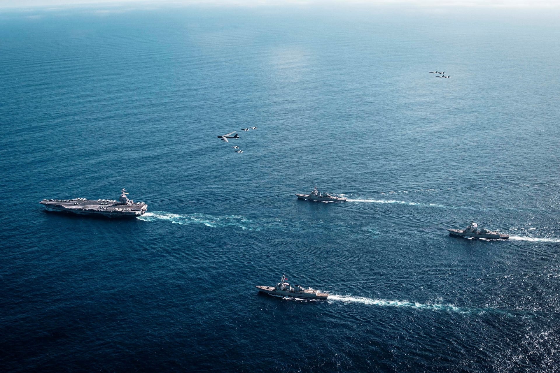<p>The U.S. Navy’s Gerald R. Ford Carrier Strike Group, including the flagship USS Gerald R. Ford, USS Winston S. Churchill, USS Mahan and USS Bainbridge, sail towards the Caribbean Sea under F/A-18E/F Super Hornets and a U.S. Air Force B-52 Stratofortress, in the Atlantic Ocean November 13, 2025.</p>