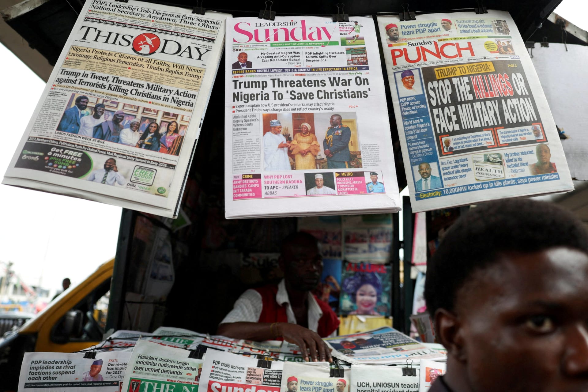 <p>Newspapers with articles reporting U.S. President Donald Trump’s message to Nigeria over the treatment of Christians hang at a newspaper stand in Ojuelegba, Lagos, Nigeria, on November 2, 2025.</p>
