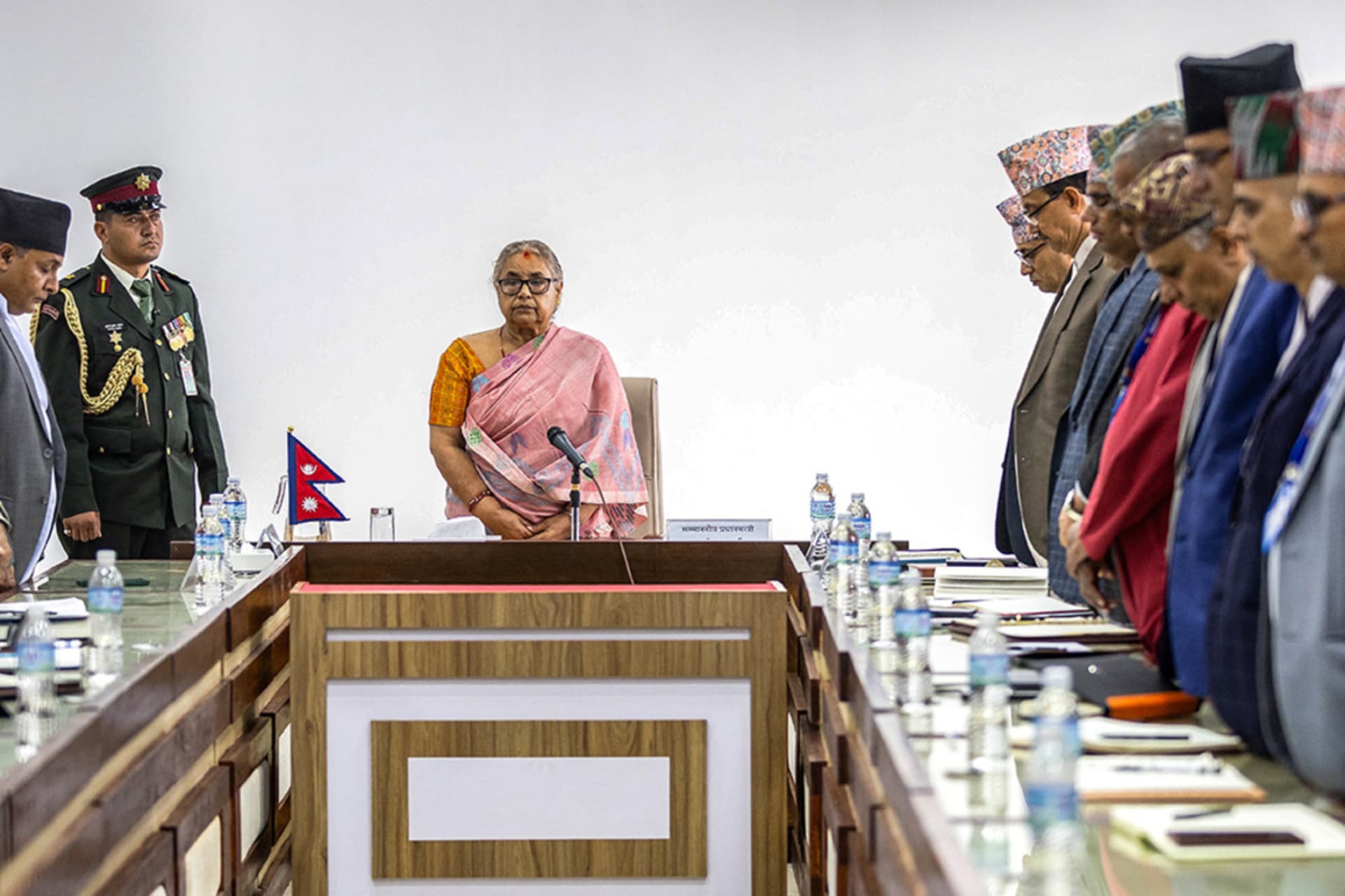<p>Newly-elected Prime Minister of Nepal’s interim government Sushila Karki (C), along with officials, observes a moment of silence to pay her tribute to those who lost their lives in recent protests in Kathmandu on September 14, 2025.</p>
