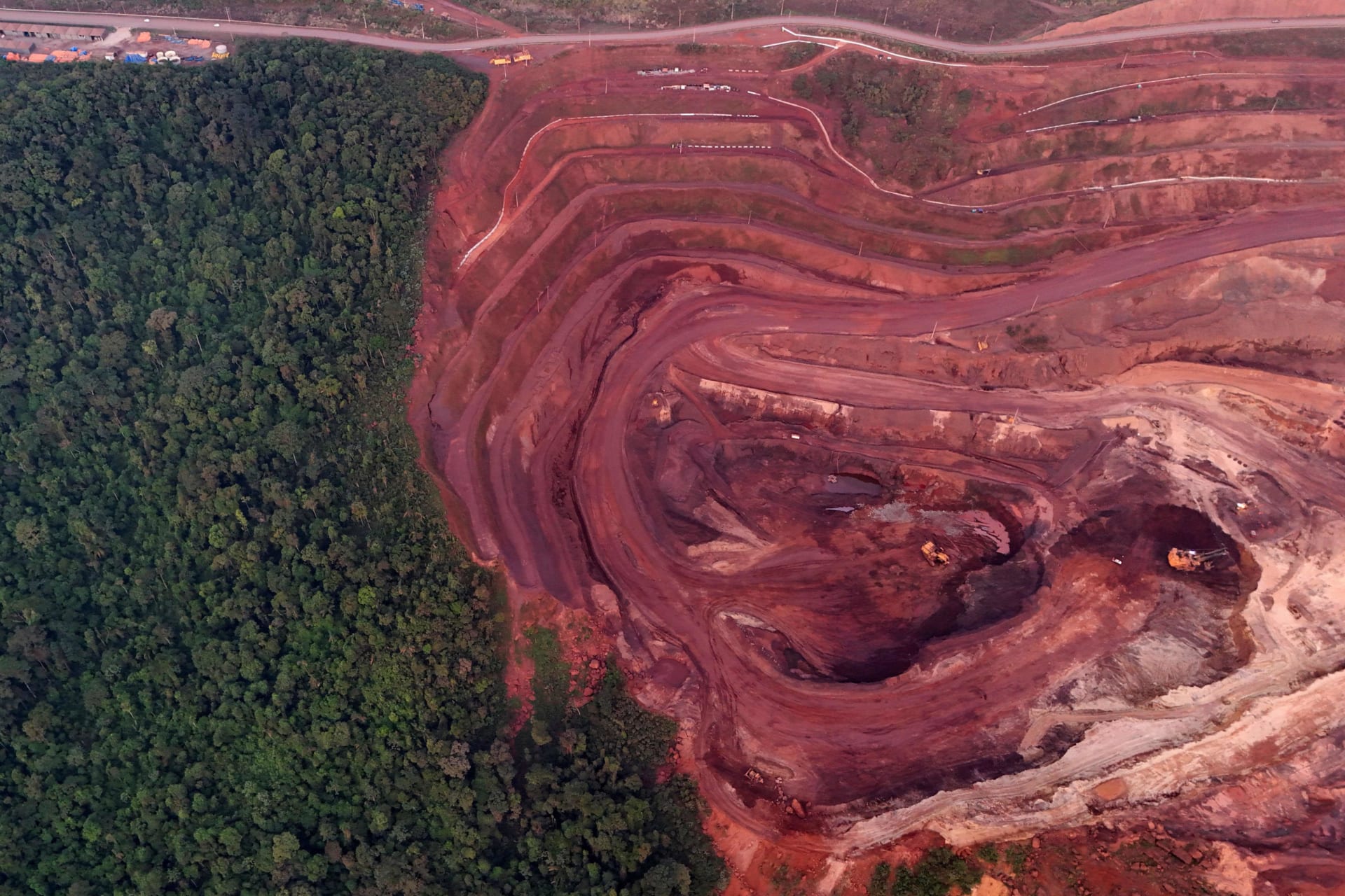 <p>A drone view of the world’s largest iron ore mine, run by Brazilian mining company Vale in the middle of a vast rainforest preserve, where autonomous mining vehicles are used to increase productivity by operating around the clock in hazardous environments</p>
