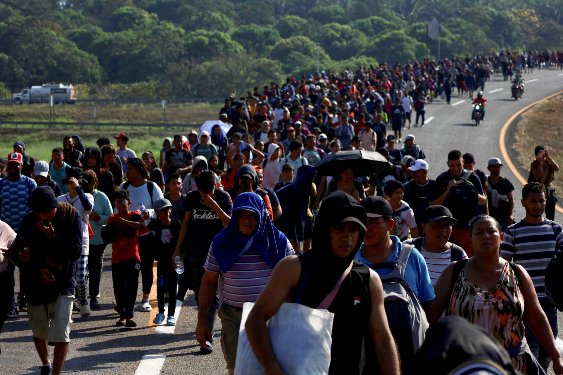 A group of migrants walk toward the U.S.-Mexico border