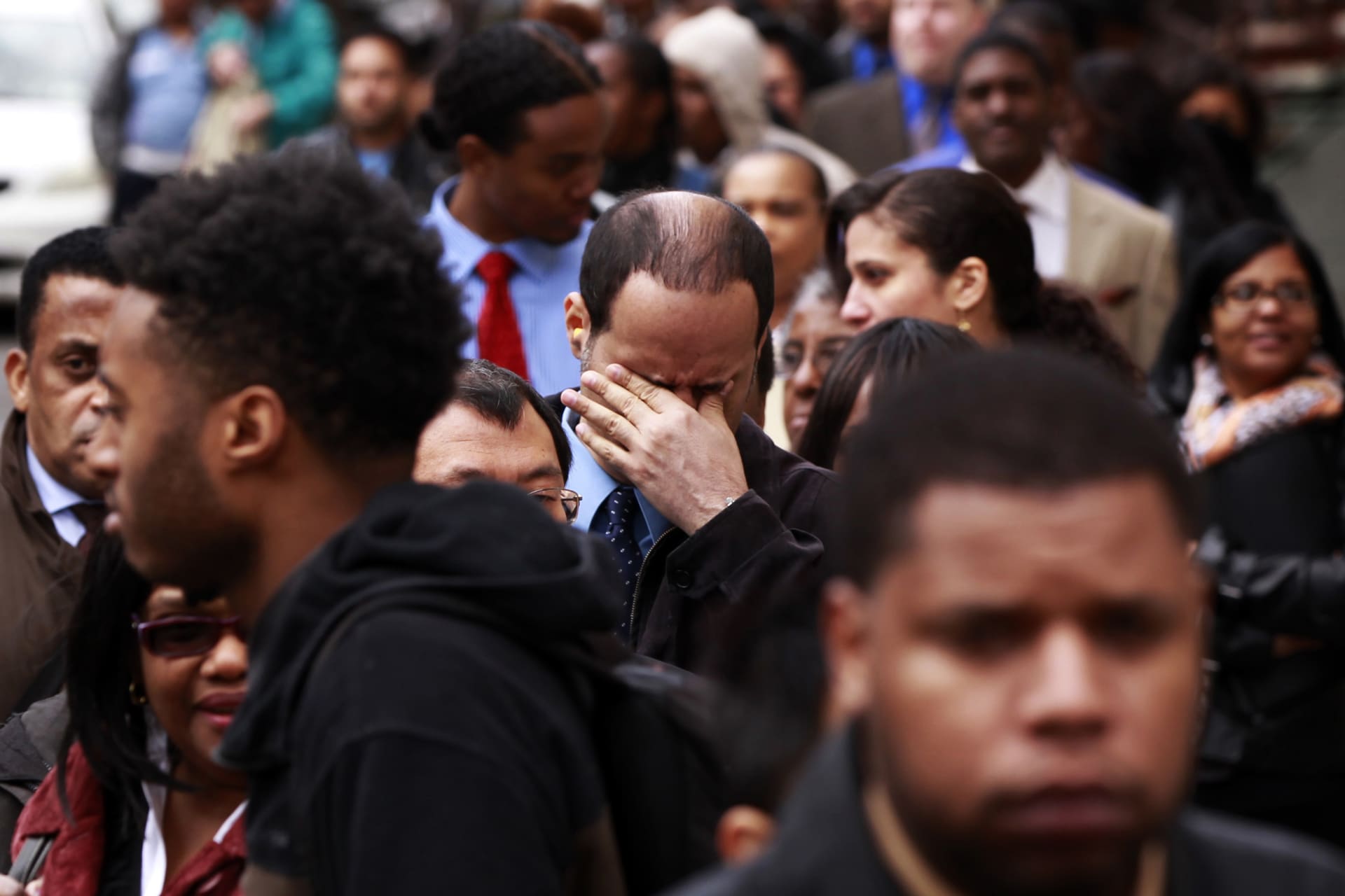 <p>A man rubs his eyes as he waits in a line of jobseekers to attend the Dr. Martin Luther King Jr. career fair held by the New York State department of Labor in New York on April 12, 2012.</p>
