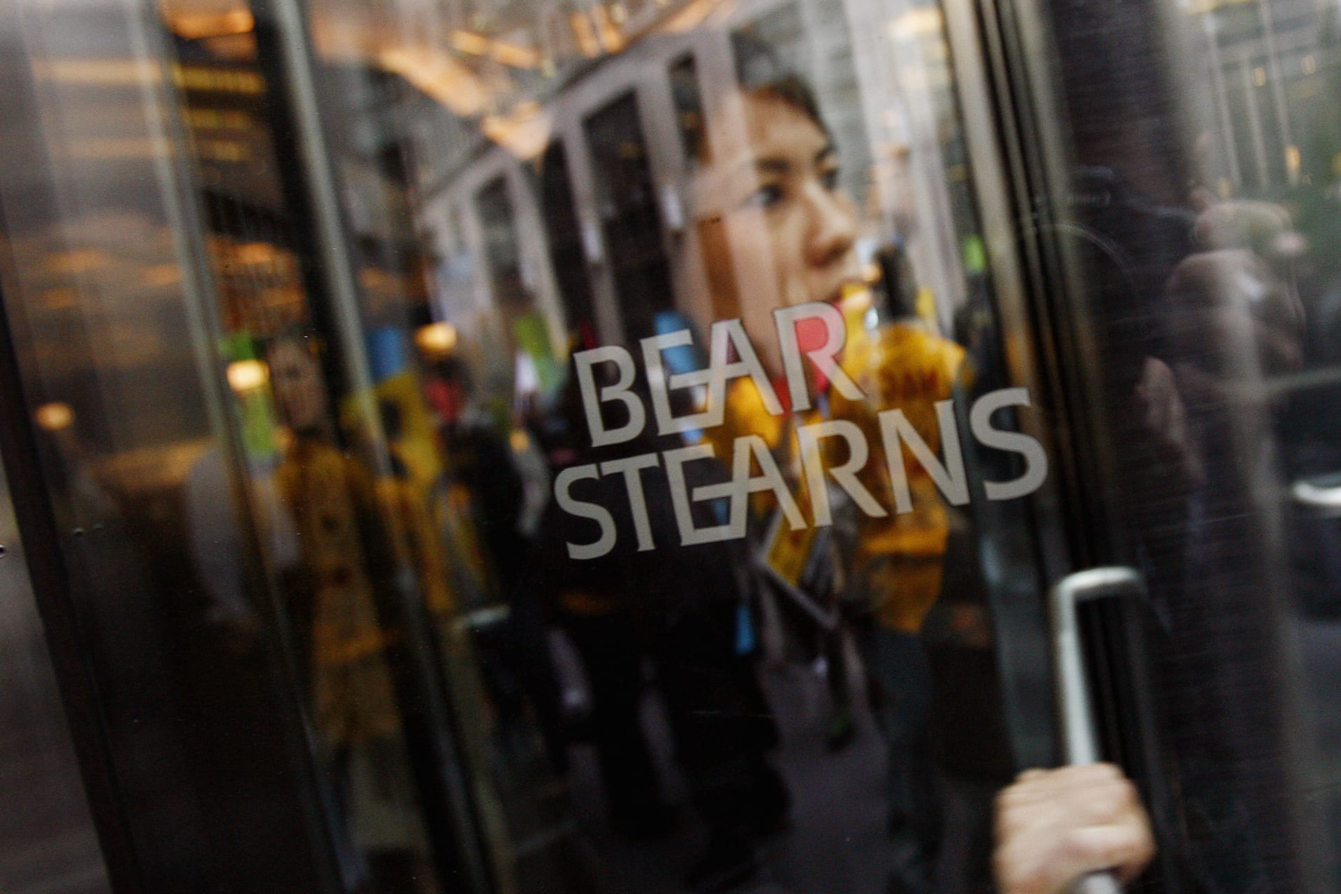 <p>An employee of Bear Stearns leaves as demonstrators from the Neighborhood Assistance Corporation of America protest outside the Bear Stearns headquarters in New York on March 26, 2008.</p>
