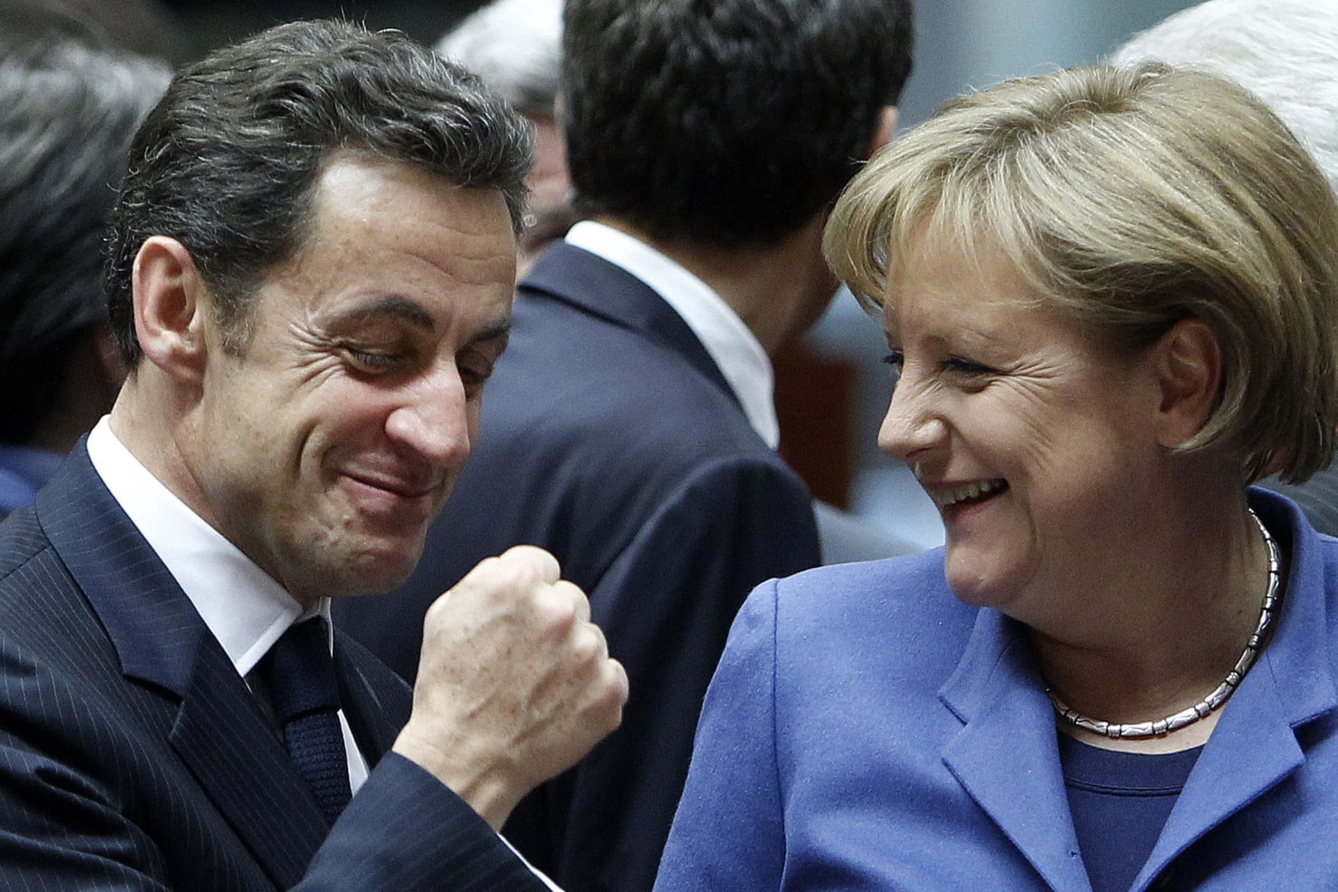 <p>France’s President Nicolas Sarkozy (L) gestures beside German Chancellor Angela Merkel at the start of a European Union leaders summit in Brussels on March 25, 2010.</p>
