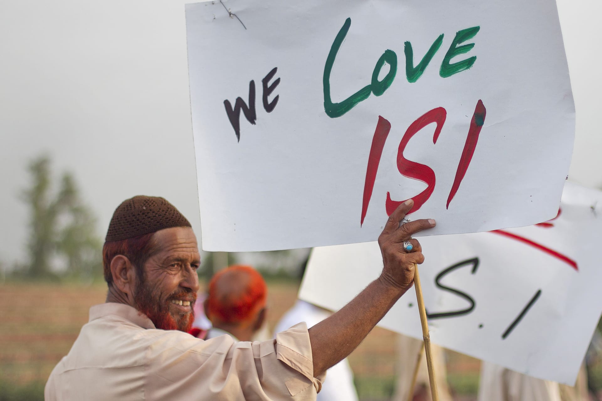 <p>An activist associated with a social group from a citizen forum holds a placard as protesters rally in favour of Pakistan’s army and Inter-Services Intelligence (ISI) in Islamabad on May 11, 2011.</p>
