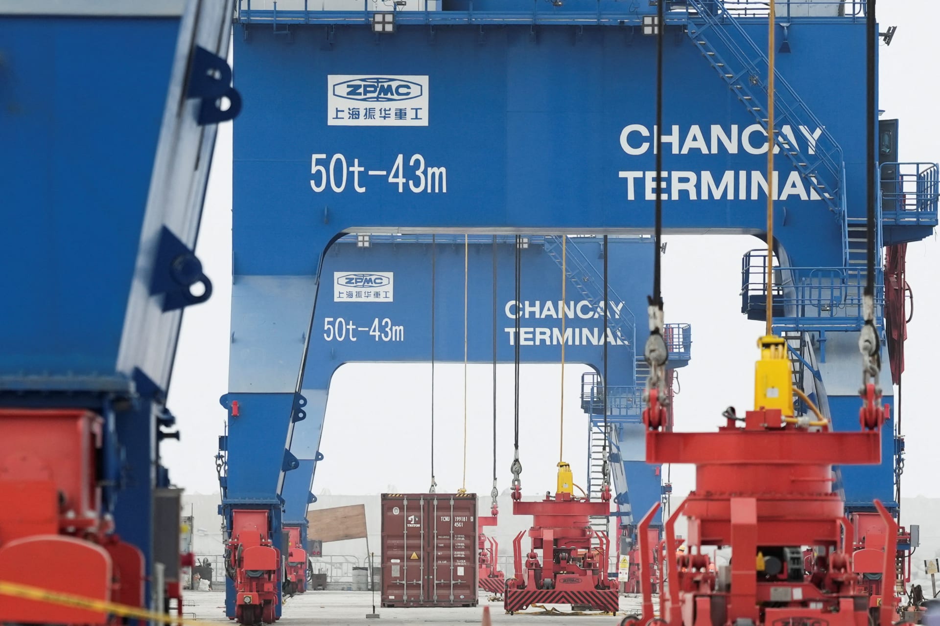 A crane moves a container at the new megaport being built by China's state-owned Cosco Shipping