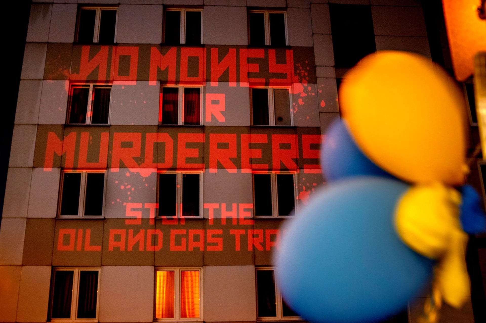 <p>The words “No Money for Murderers, Stop the Oil and Gas Trade” are projected by activists onto the Russian consulate in Frankfurt on April 4. </p>
