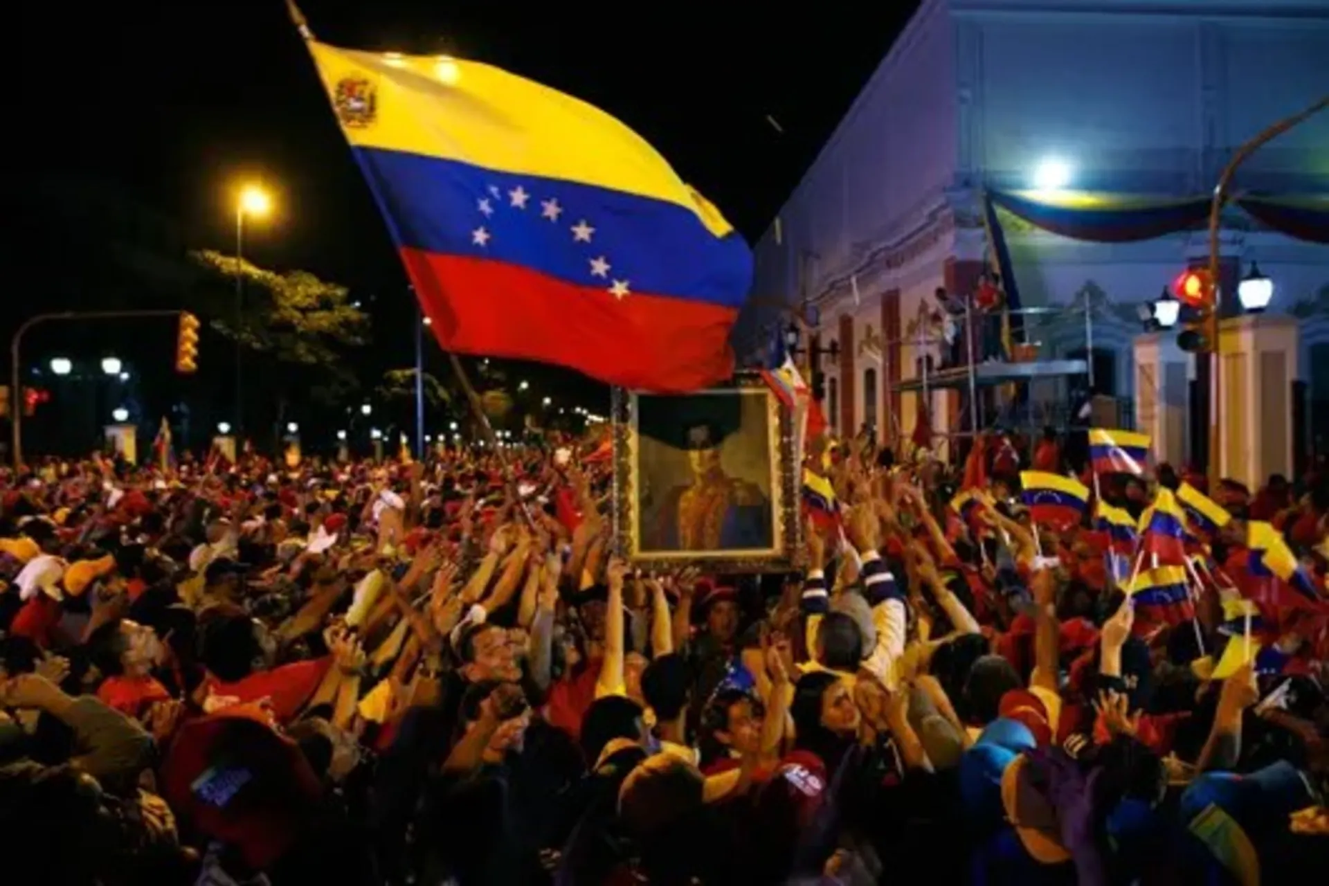 Chavez supporters mob the gate of Miraflores Palace in Caracas after the referendum to abolish term limits passes. 