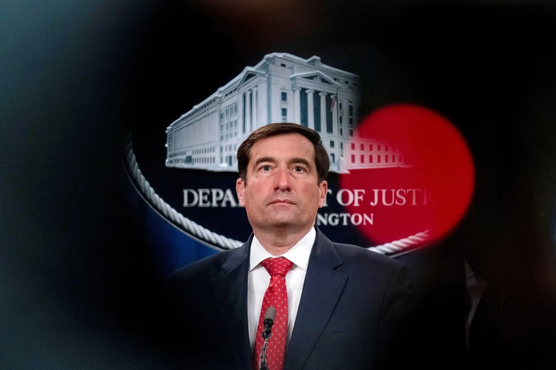 U.S. Assistant Attorney General for the National Security Division John Demers takes a question from a reporter.