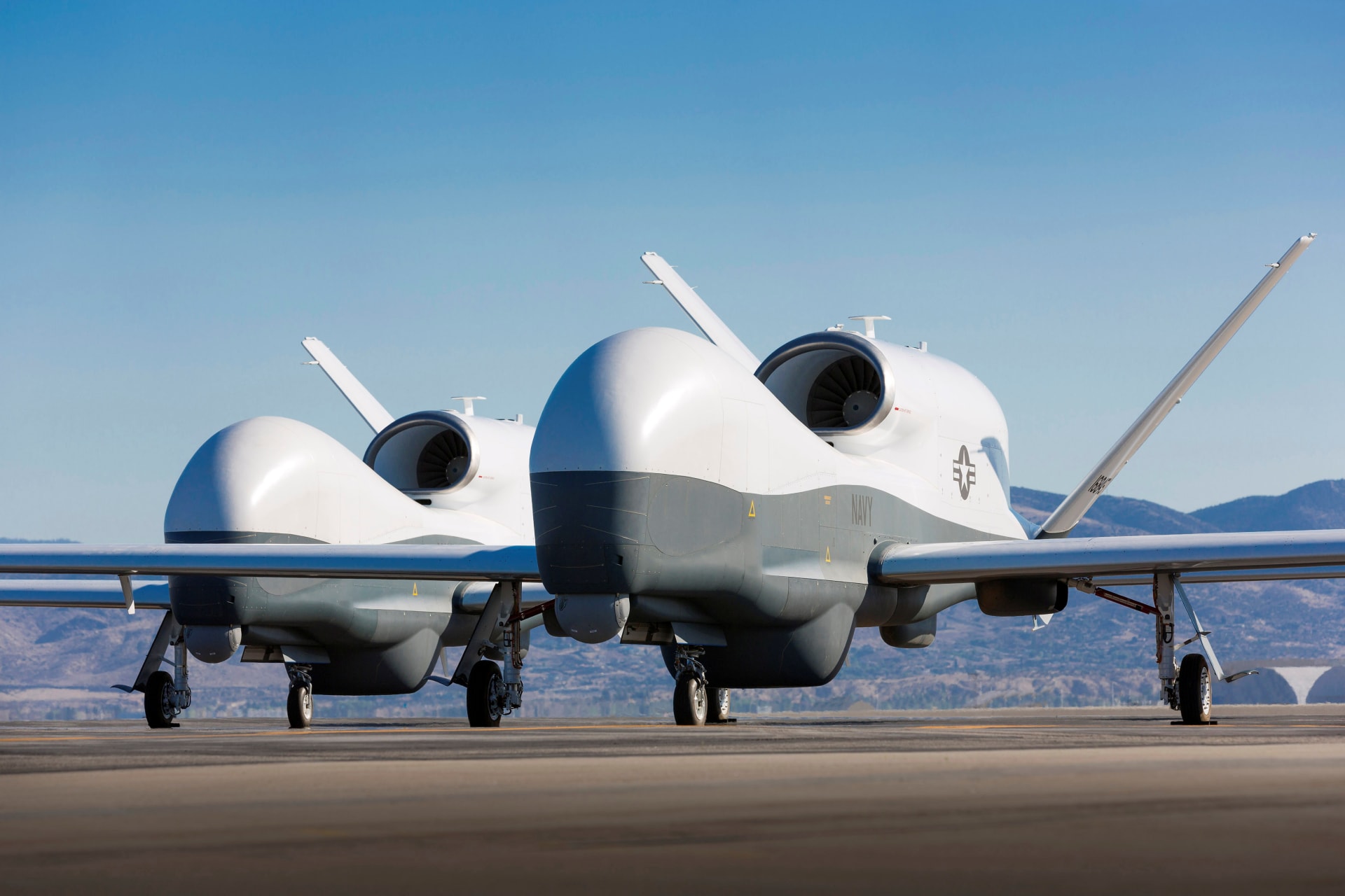 <p>Two Northrop Grumman MQ-4C Triton unmanned aerial vehicles are seen on the tarmac at a Northrop Grumman test facility in Palmdale, California on May 22, 2013</p>