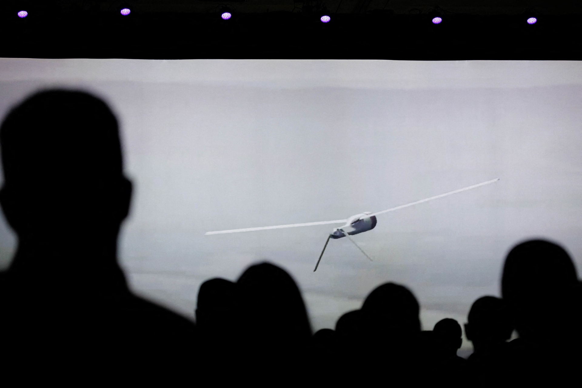 <p>Attendees at the Xponential 2024 show, a technology event for autonomous systems held in San Diego, view a video showing a drone in flight. April 23, 2024.</p>
