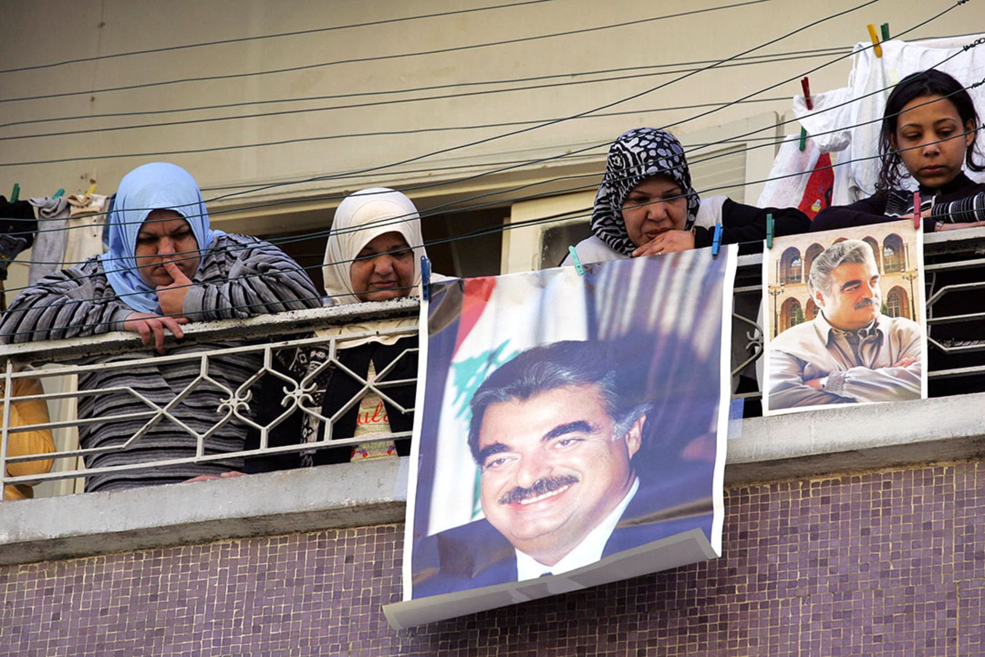 Sunni Muslim women in Beirut brandish posters of assassinated former Lebanese Prime Minister Rafiq Hariri. 

