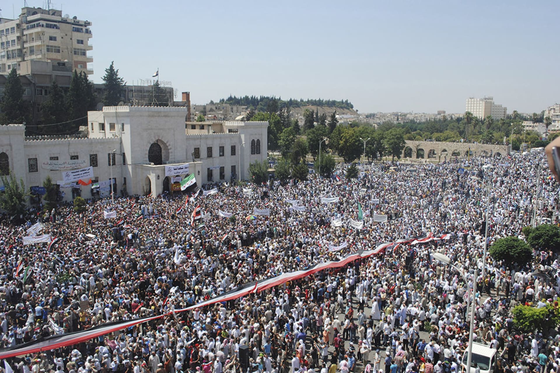 Protestors stand in the city center of Hama, Syria, during a rally against President Bashar al-Assad’s government in July, 2011.
