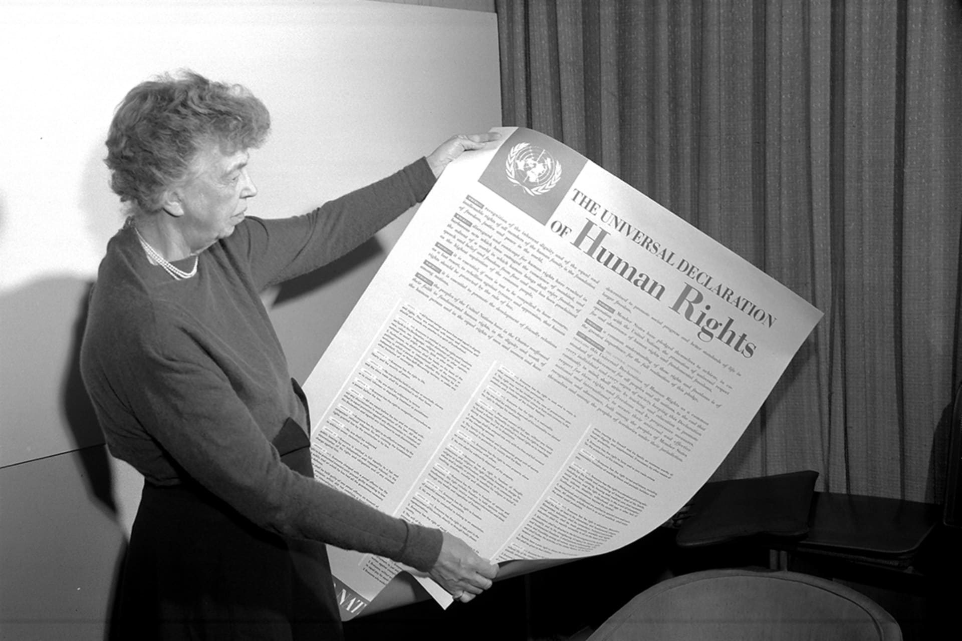 Former U.S. First Lady Eleanor Roosevelt, first chairperson of the UN Commission on Human Rights, holds a poster of the UDHR. UN Photo