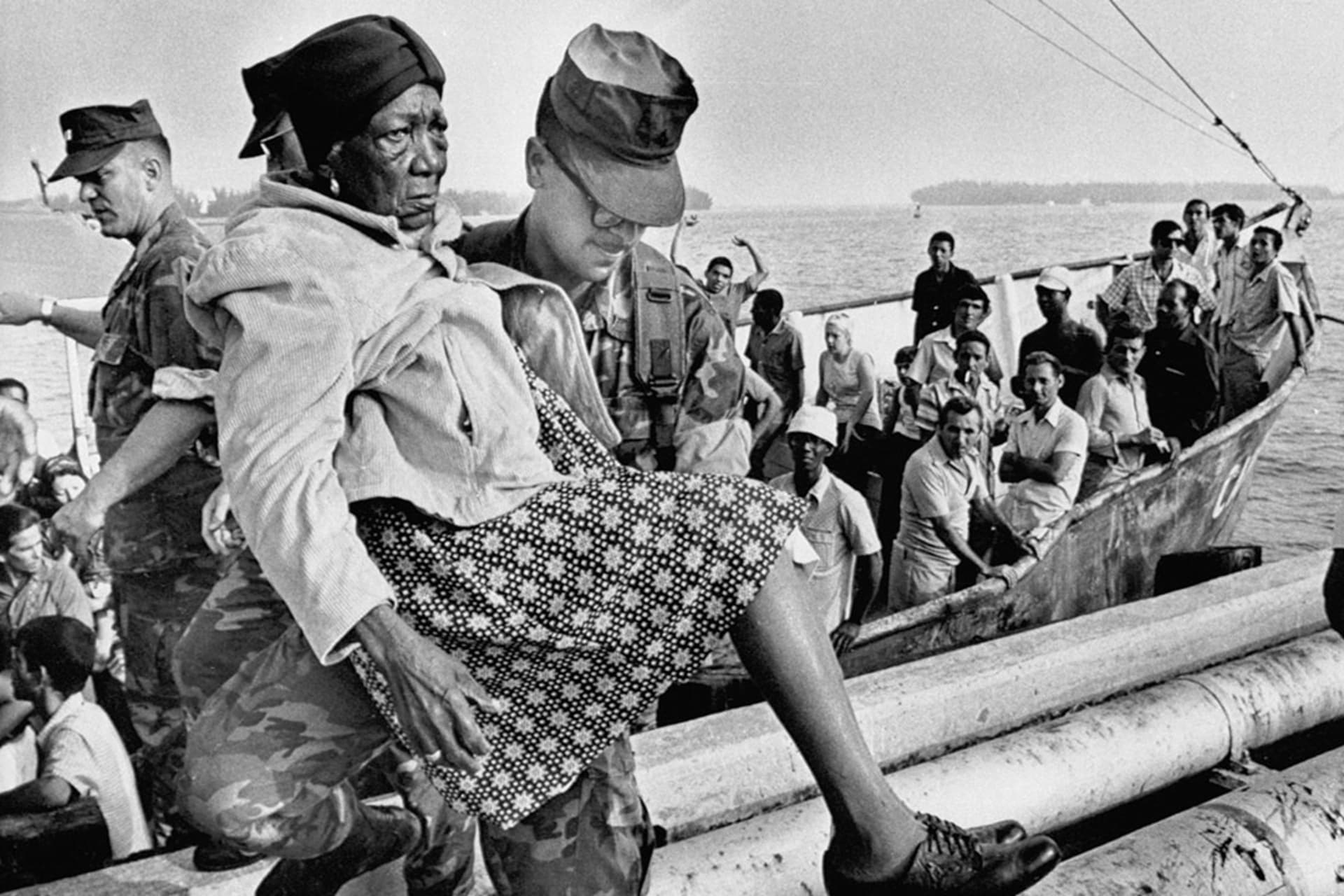 A U.S. Marine carries a Cuban refugee ashore. Bettmann/Getty Images