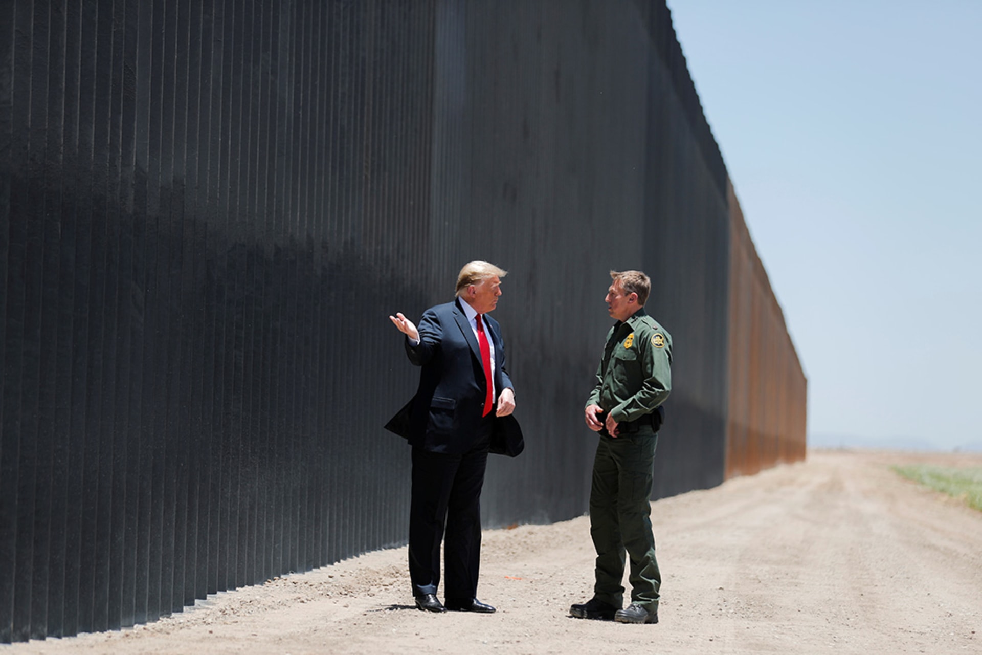 Trump visits a section of the U.S. border wall with the head of Border Patrol, Rodney Scott, in June 2020. Carlos Barria/Reuters