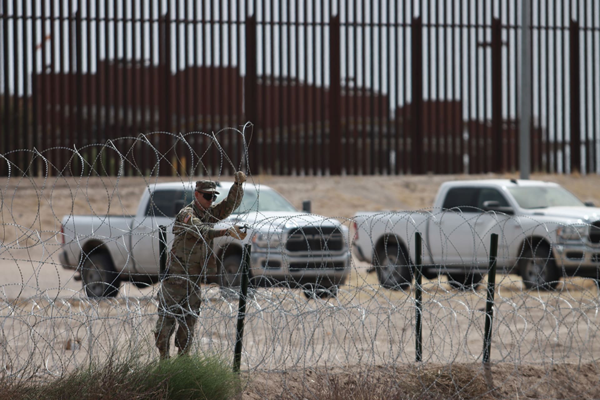 A member of the Texas National Guard puts up fencing along the U.S.-Mexico border to prepare for a surge in migration that is expected after Title 42 ends. Christian Torres Chavez/Anadolu Agency/Getty Images