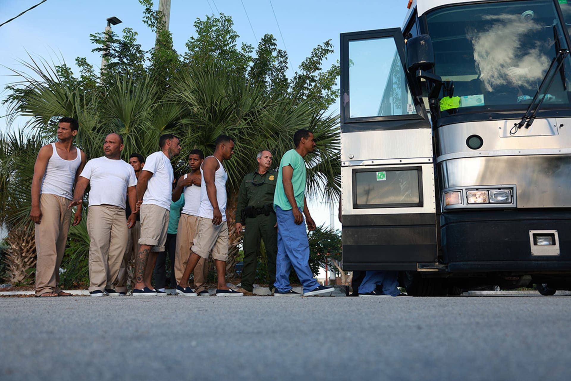 A group of Cuban migrants boards a bus that will take them to a U.S. Customs and Border Protection station to be processed in Marathon, Florida. 