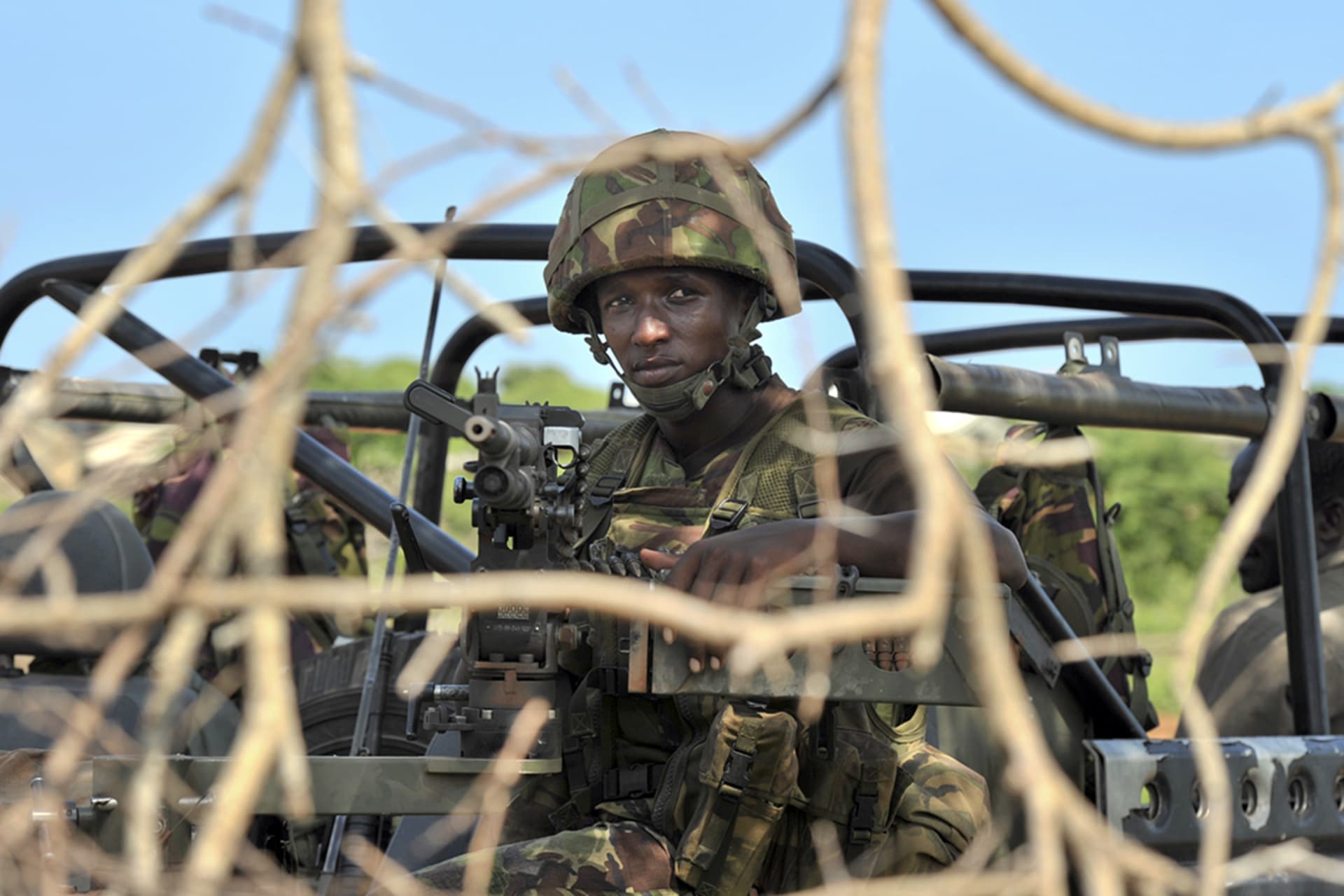 A member of the Kenyan Defense Force looks out from a military vehicle in Ras Kamboni, Somalia. Carl de Souza/AFP/Getty Images
