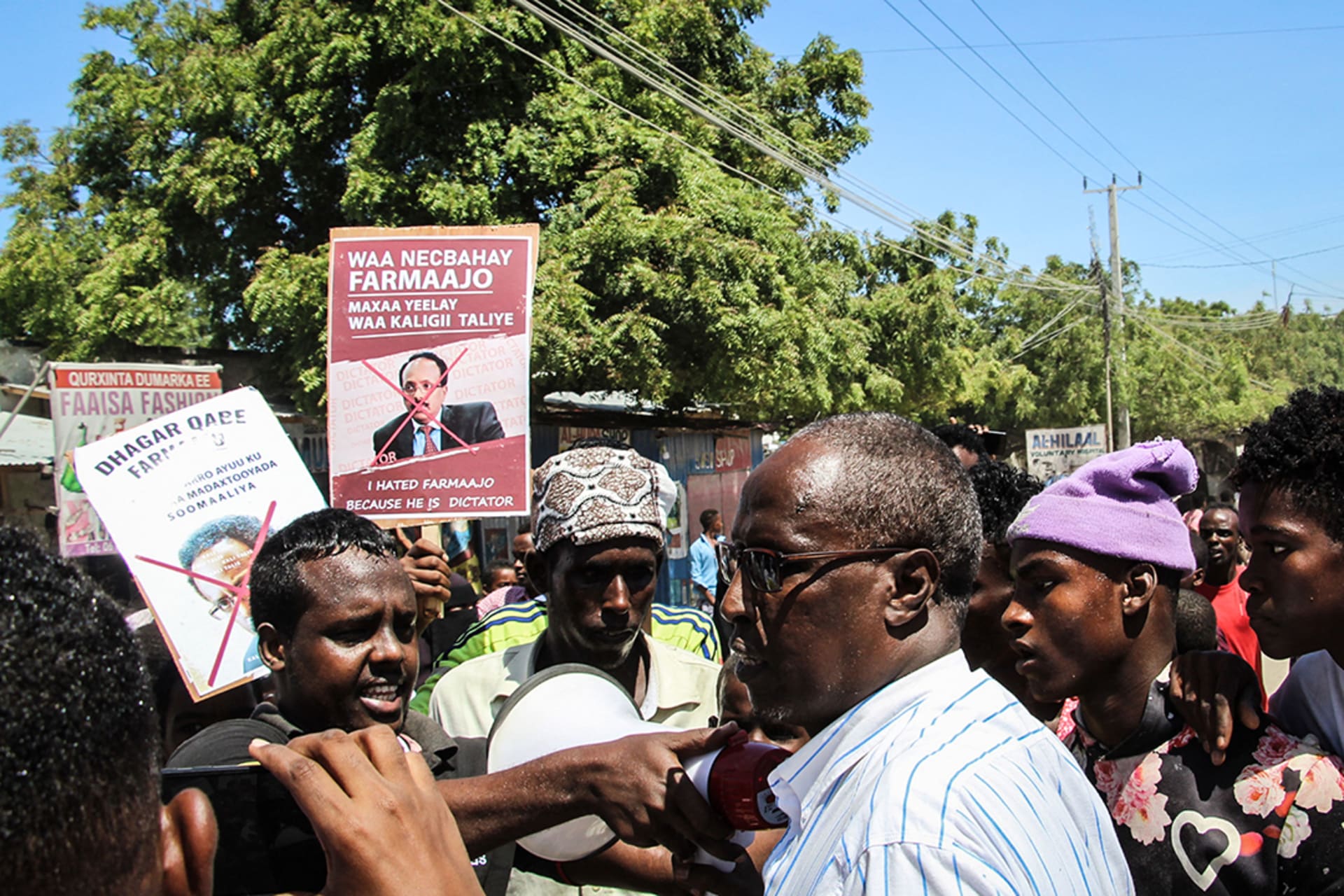 People hold posters during a protest against Farmaajo in Mogadishu on April 25, 2021. 
