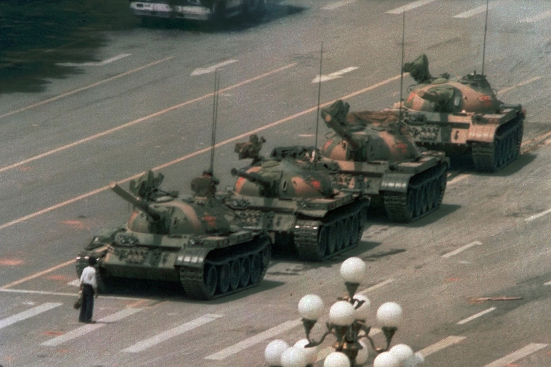 A lone protester confronts military tanks in Tiananmen Square. 
