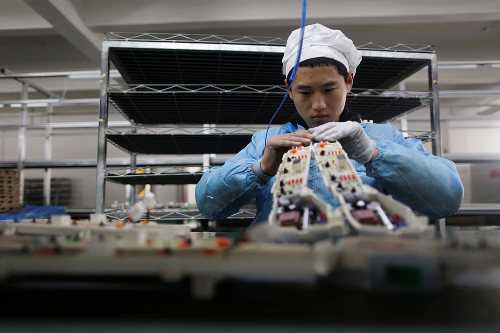 A person works in an electronics factory in Qingdao. 

