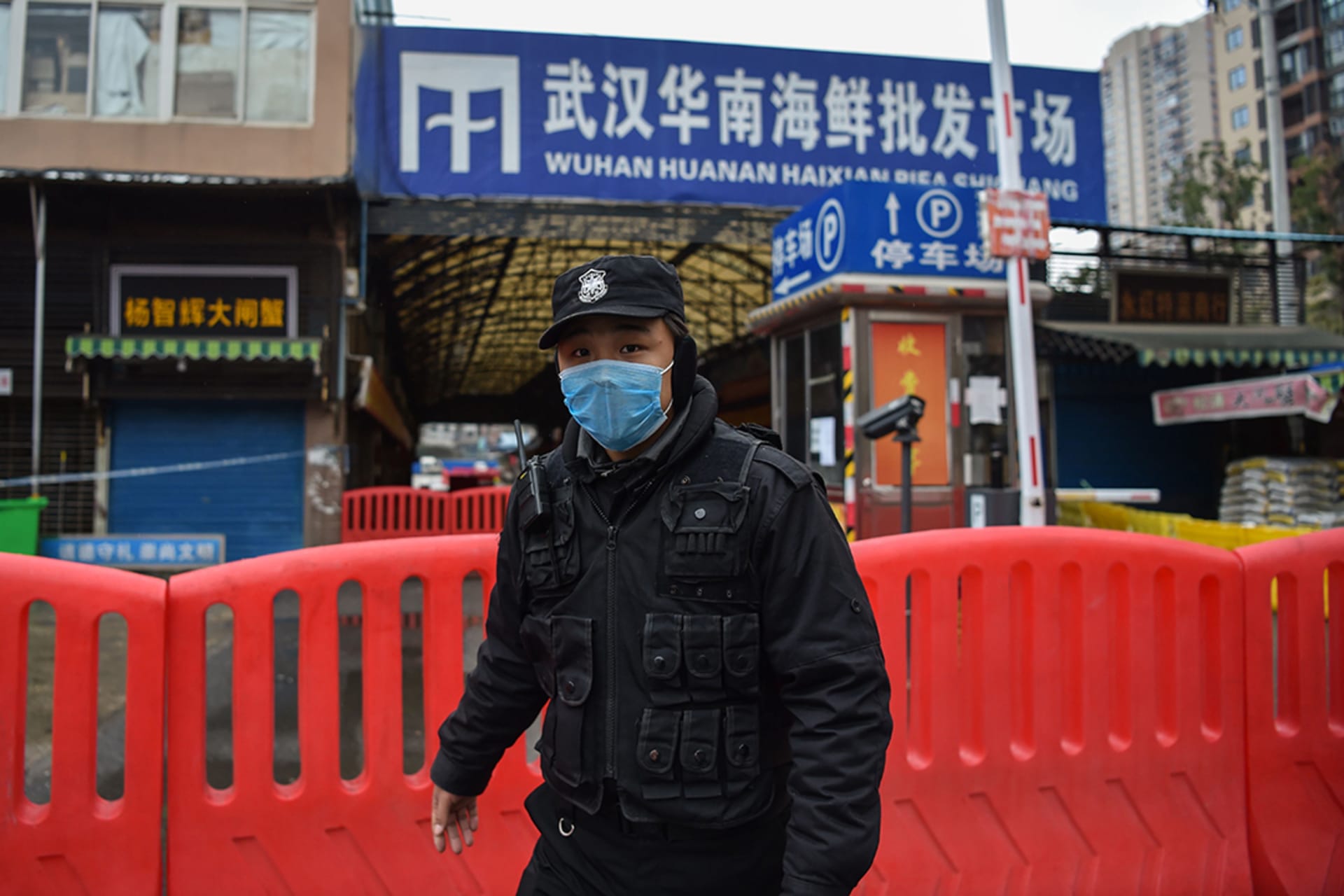 A police officer guards an animal market in Wuhan, China, where a new coronavirus was reported in January. 
