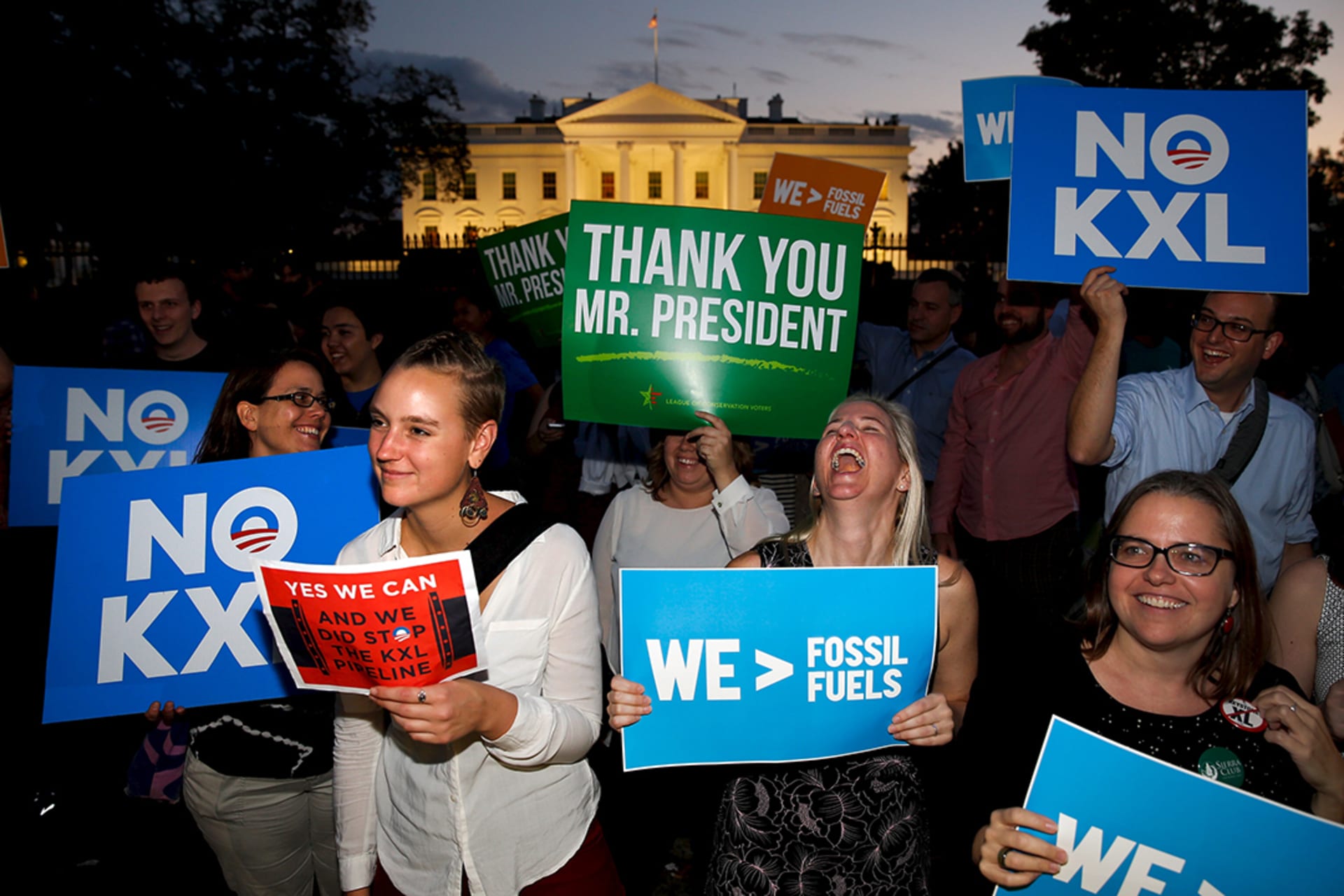 Environmental activists celebrate the rejection of the Keystone XL pipeline outside the White House in November 2015. 

