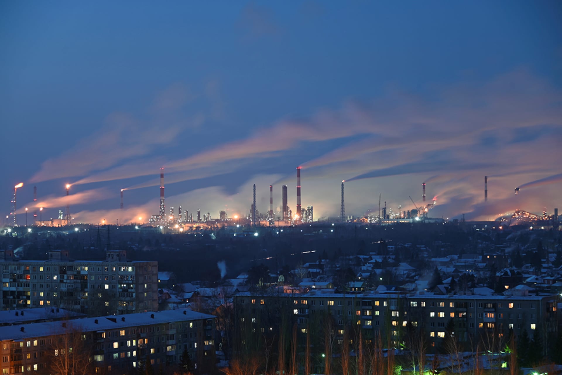 An oil refinery overlooks residential buildings in Omsk, Russia. 
