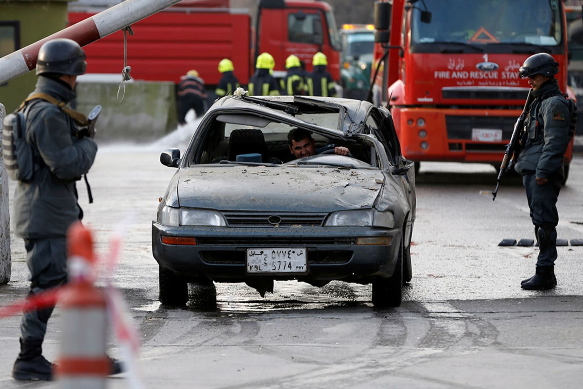 Police officers keep watch at the site of a car bomb attack in Kabul. 
