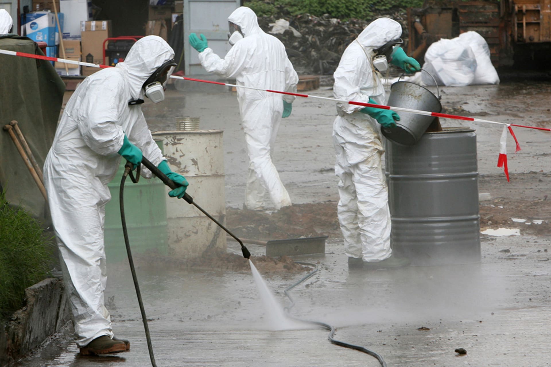 Experts clean up toxic chemical slops dumped in the Ivory Coast’s Akuedo village, September 18, 2006. 
