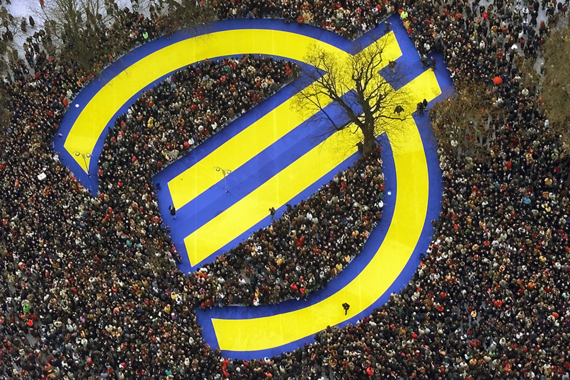 Thousands of people crowd around a huge euro symbol in Frankfurt's banking district on January 1, 1999, in celebration of the launch of the common currency. 
